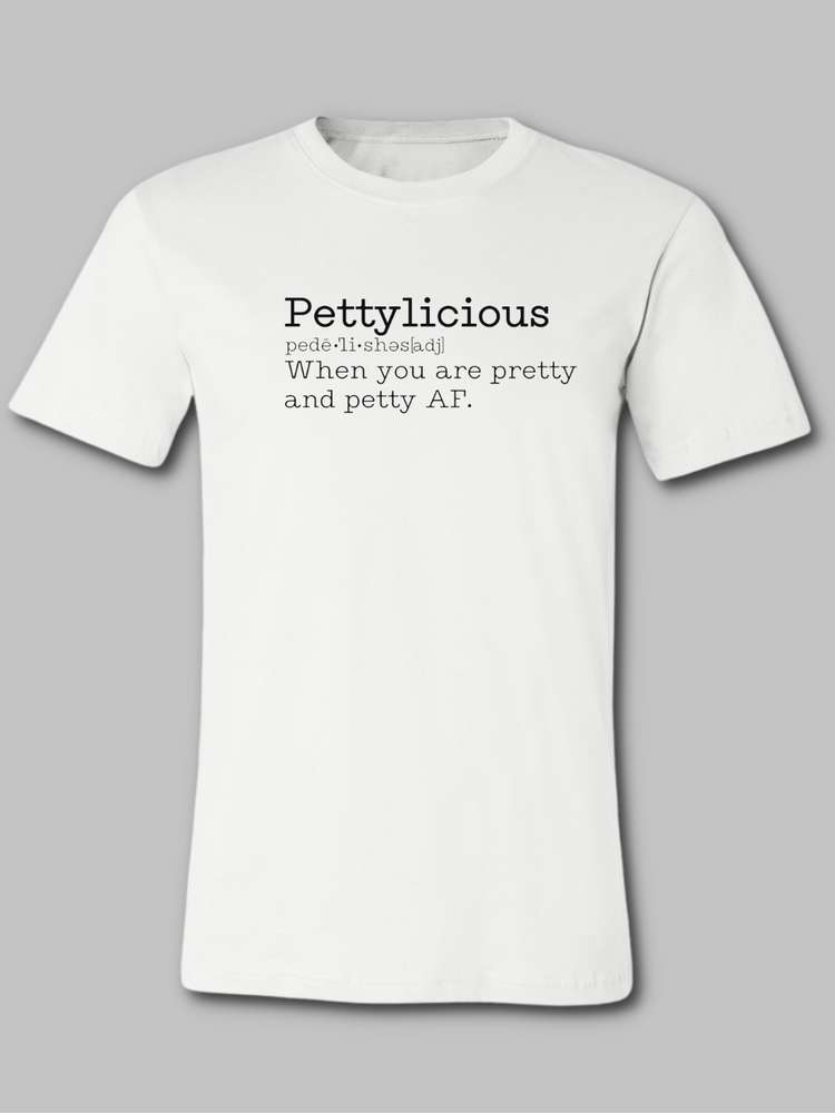 Image of a white unisex crewneck t-shirt featuring the word 'Pettylicious' in a classic black typewriter font. The playful and bold text contrasts sharply against the crisp white background of the shirt, creating a striking visual effect. The typewriter font adds a vintage, yet modern, flair to the design, emphasizing the quirky and humorous nature of the message. Sarcastic t-shirt, Petty T-shirt